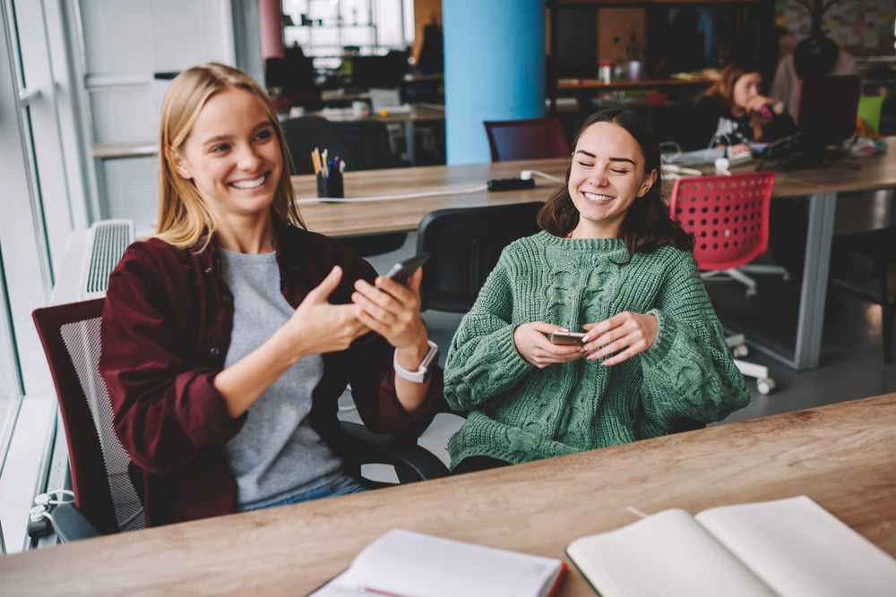 couple-of-coworkers-laughing-farewell-to-a-coworker