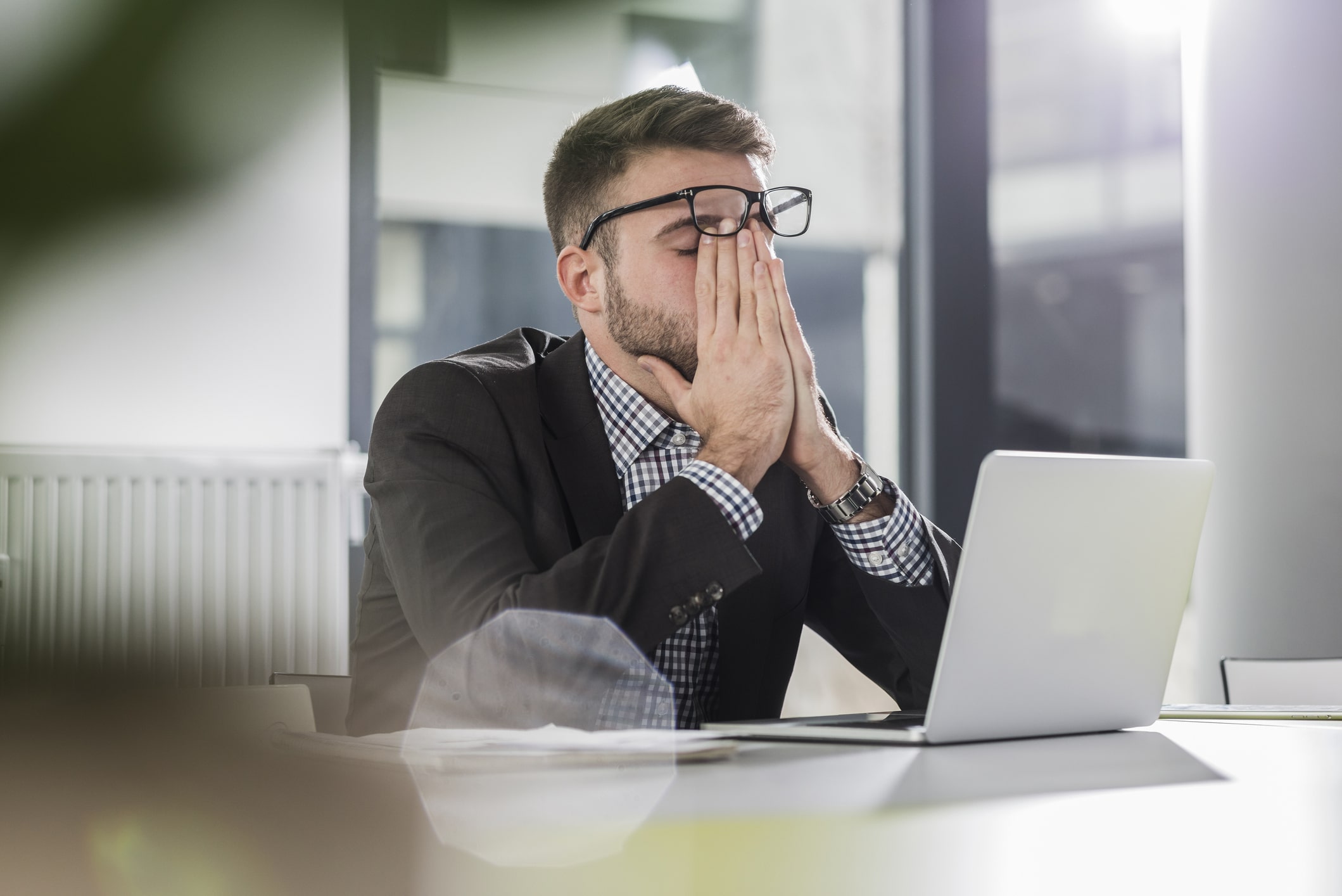 exhausted-young-man-with-laptop-in-office-motivation-vs-inspiration