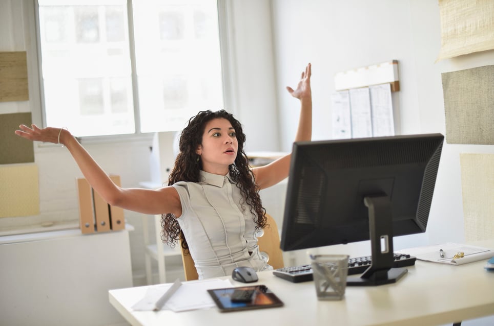 frustrated-businesswoman-on-desk-expressing-emotions