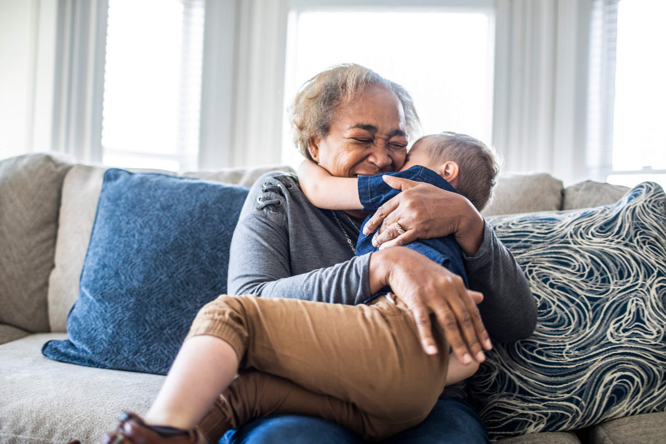 grandma-hugging-child-working-from-home-with-kids