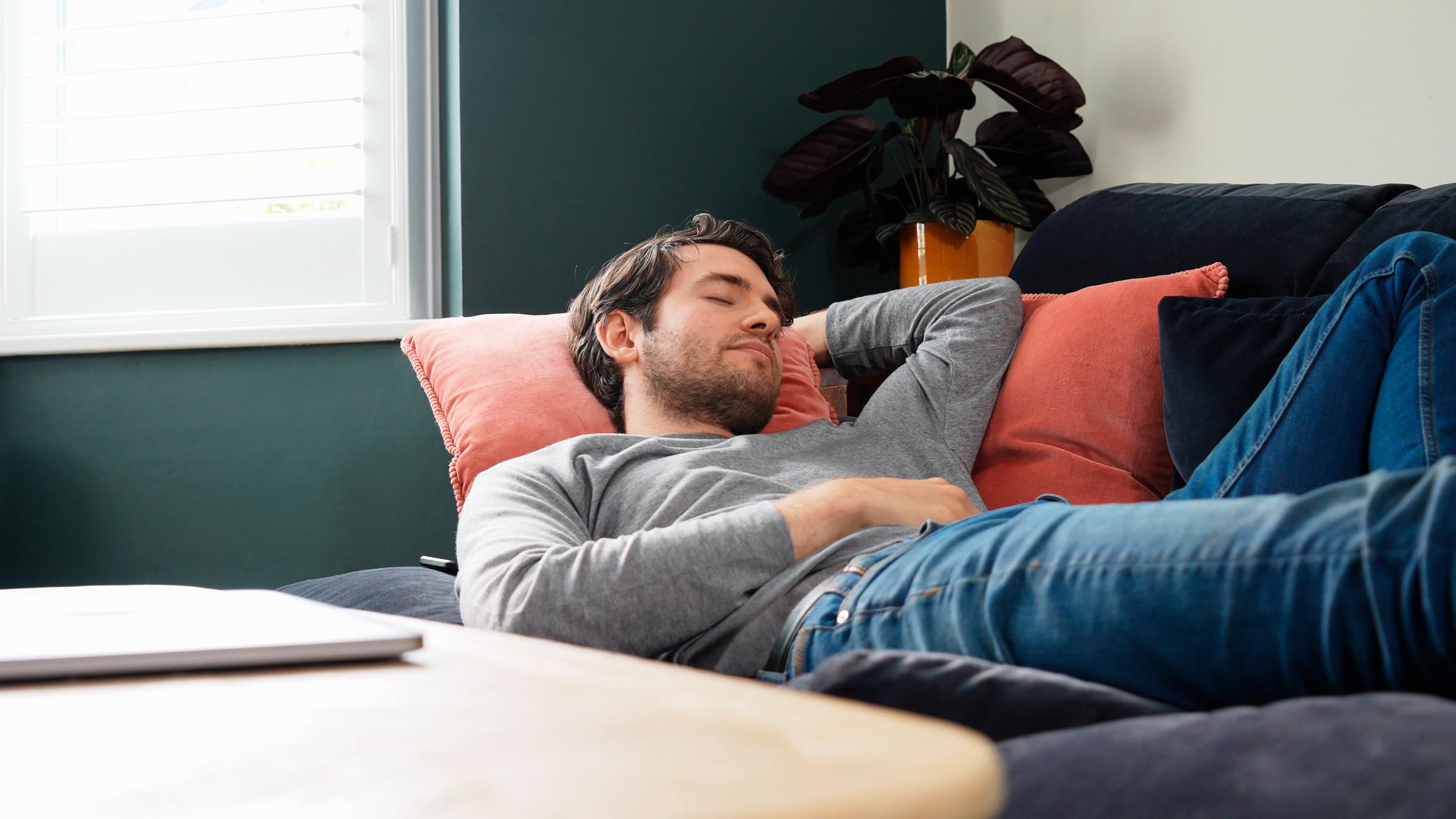 handsome-man-asleep-in-velvet-sofa-at-home-brain-fog-symptoms