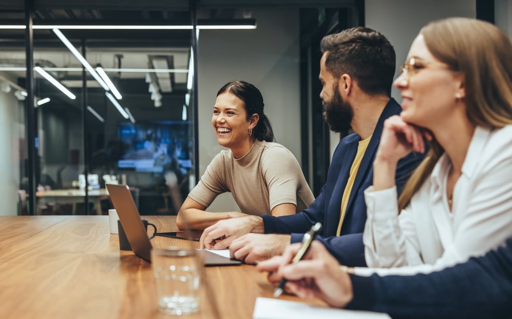 happy-businesswoman-laughing-while-leading-meeting-how-to-enjoy-life