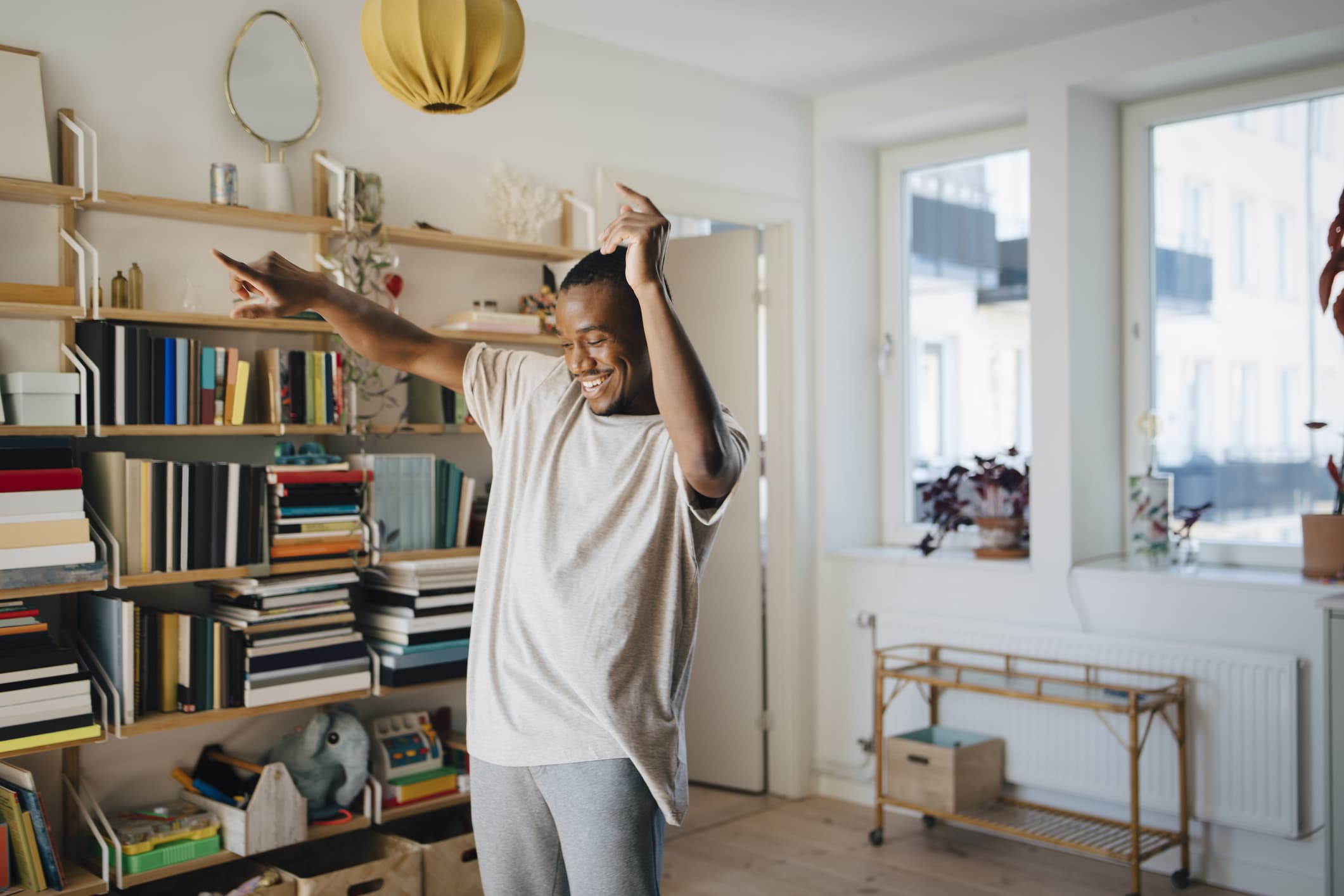 happy-man-dancing-in-living-room-at-home-how-to-use-music-to-concentrate