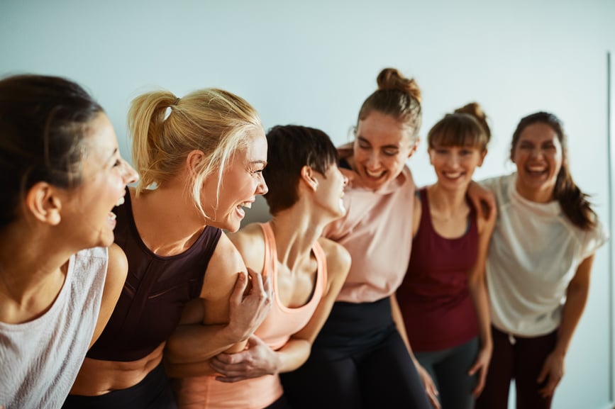 women-share-laugh-after-workout importance-of-community