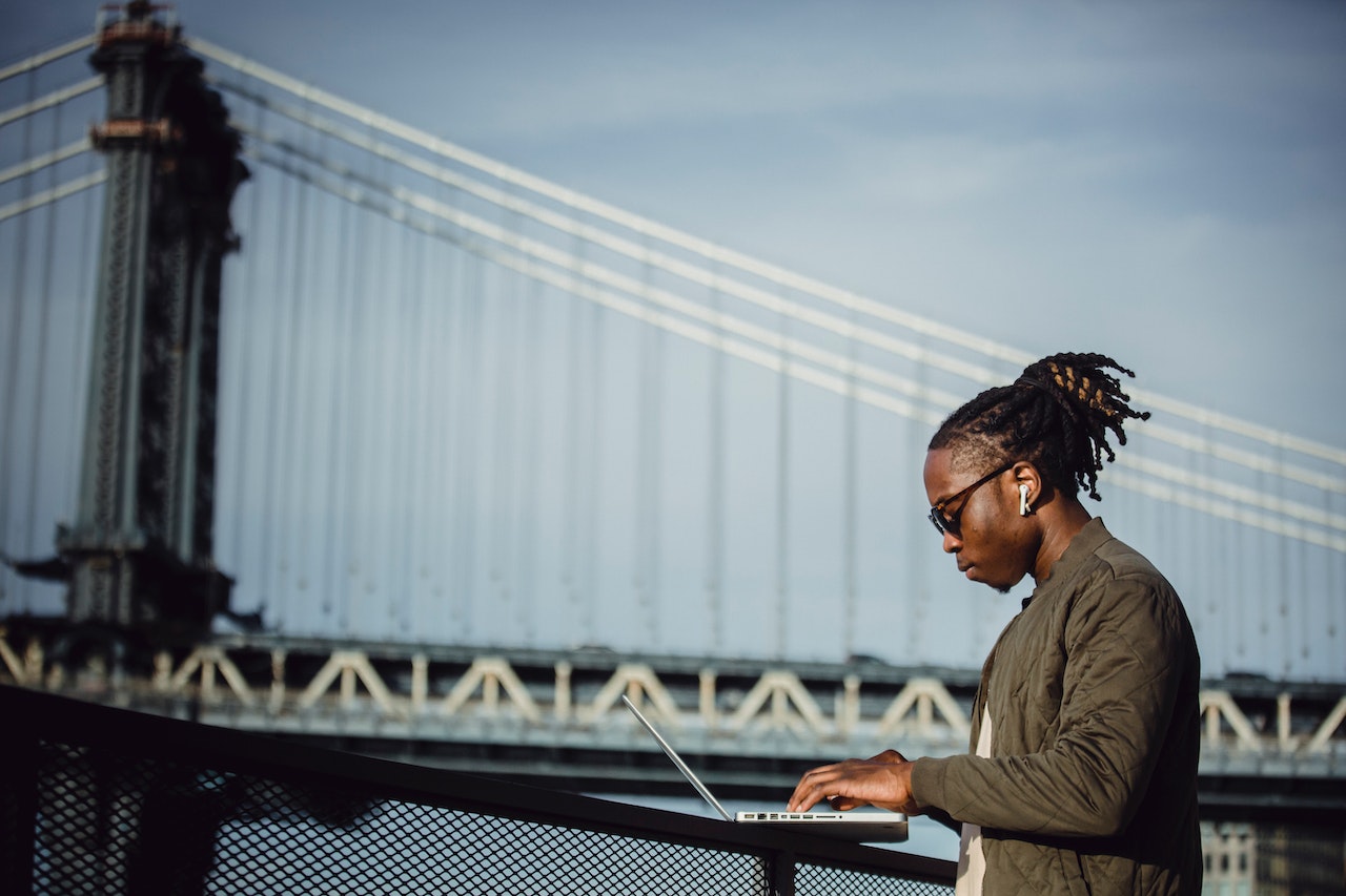 male-working-on-laptop-and-listening-to-music-how-to-prepare-for-a-new-job