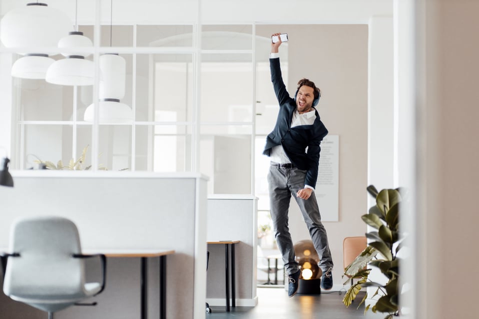 man-cheering-while-holding-phone-how-to-control-you-mind