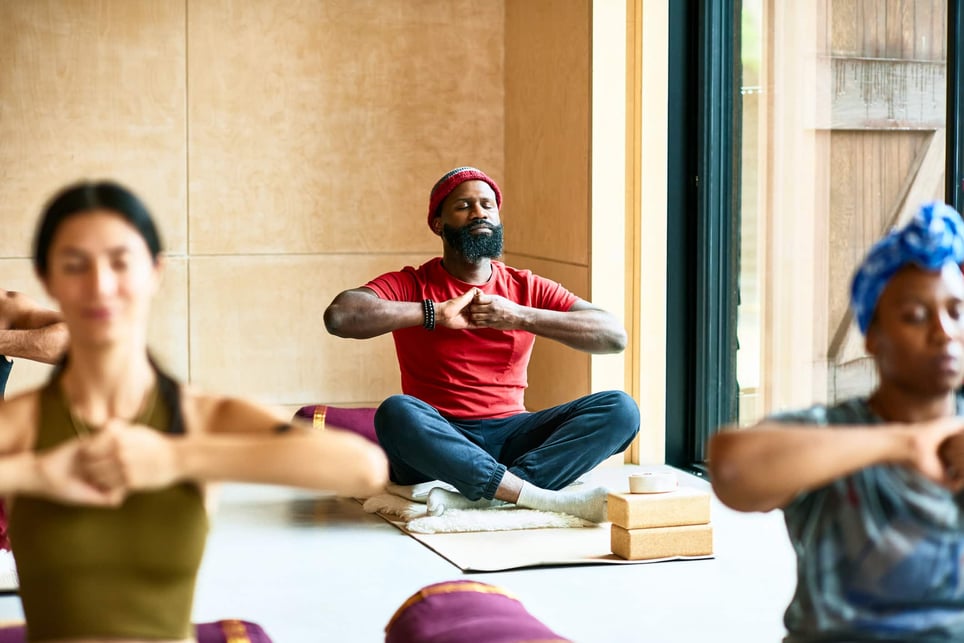 man-in-yoga-pose-with-hands-clasped-progressive-muscle-relaxation-techniques