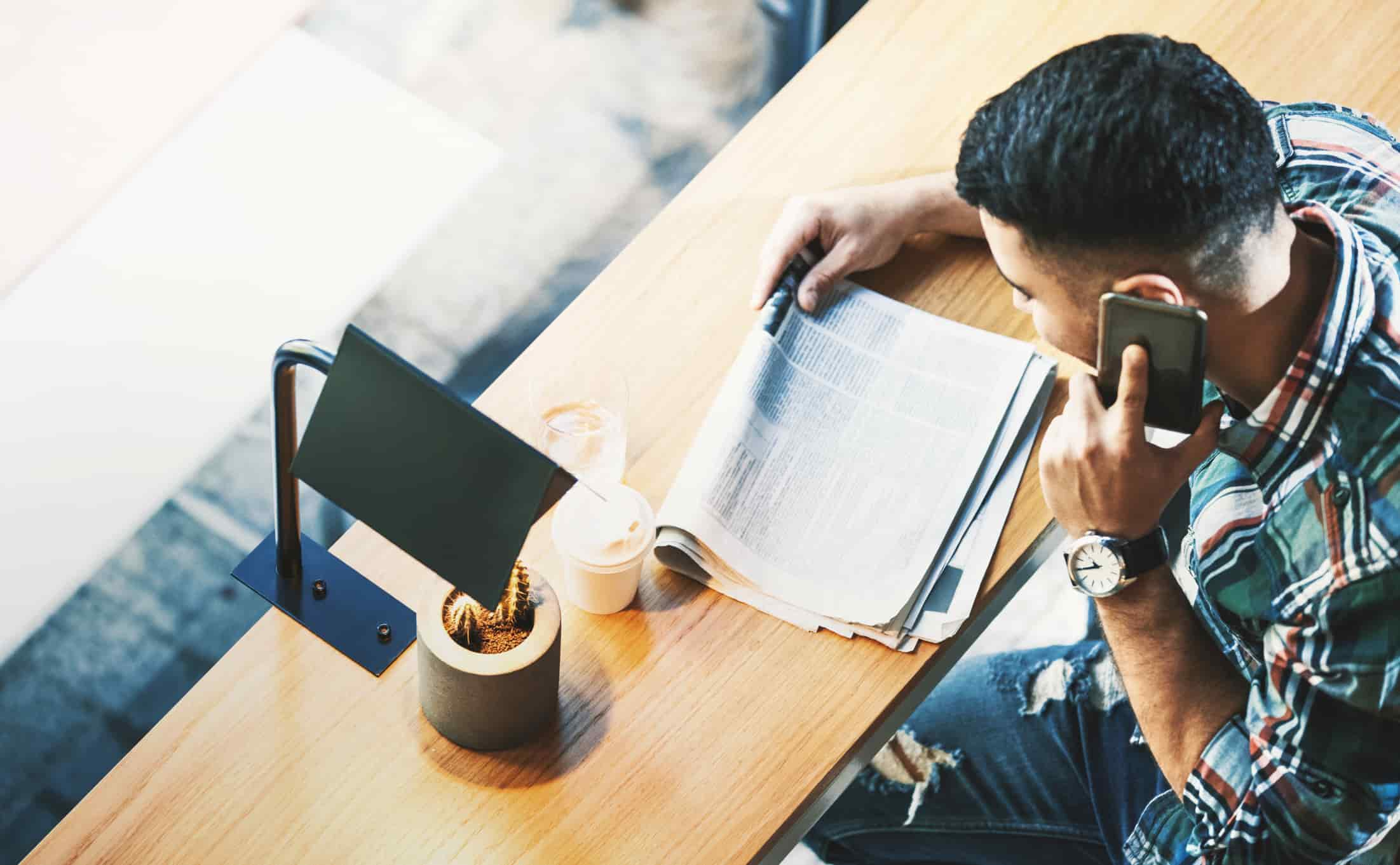 man-looking-for-a-job-on-his-phone-laid-off-from-work