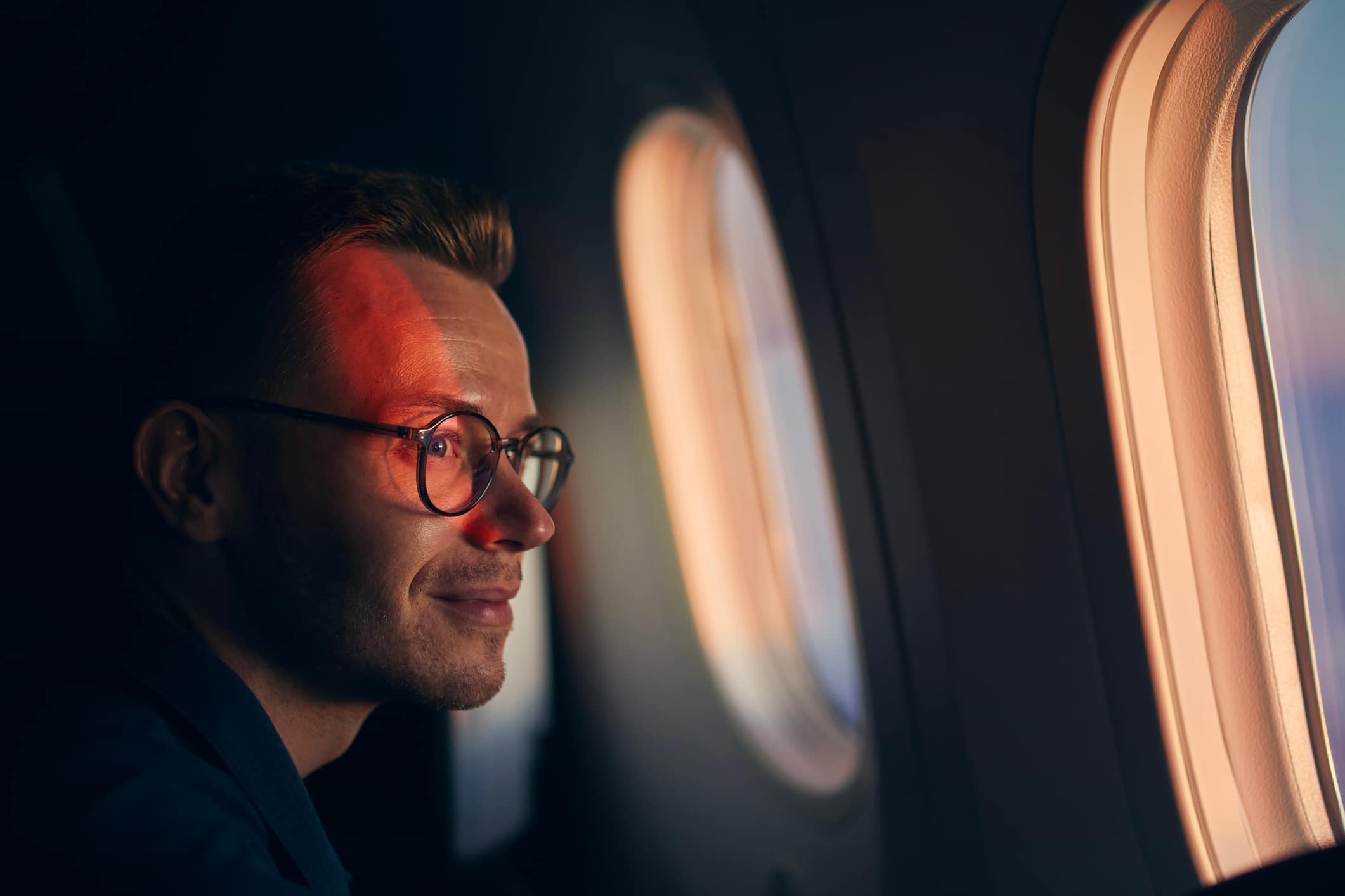 man-looking-outside-a-window-plane-fear-as-a-motivator