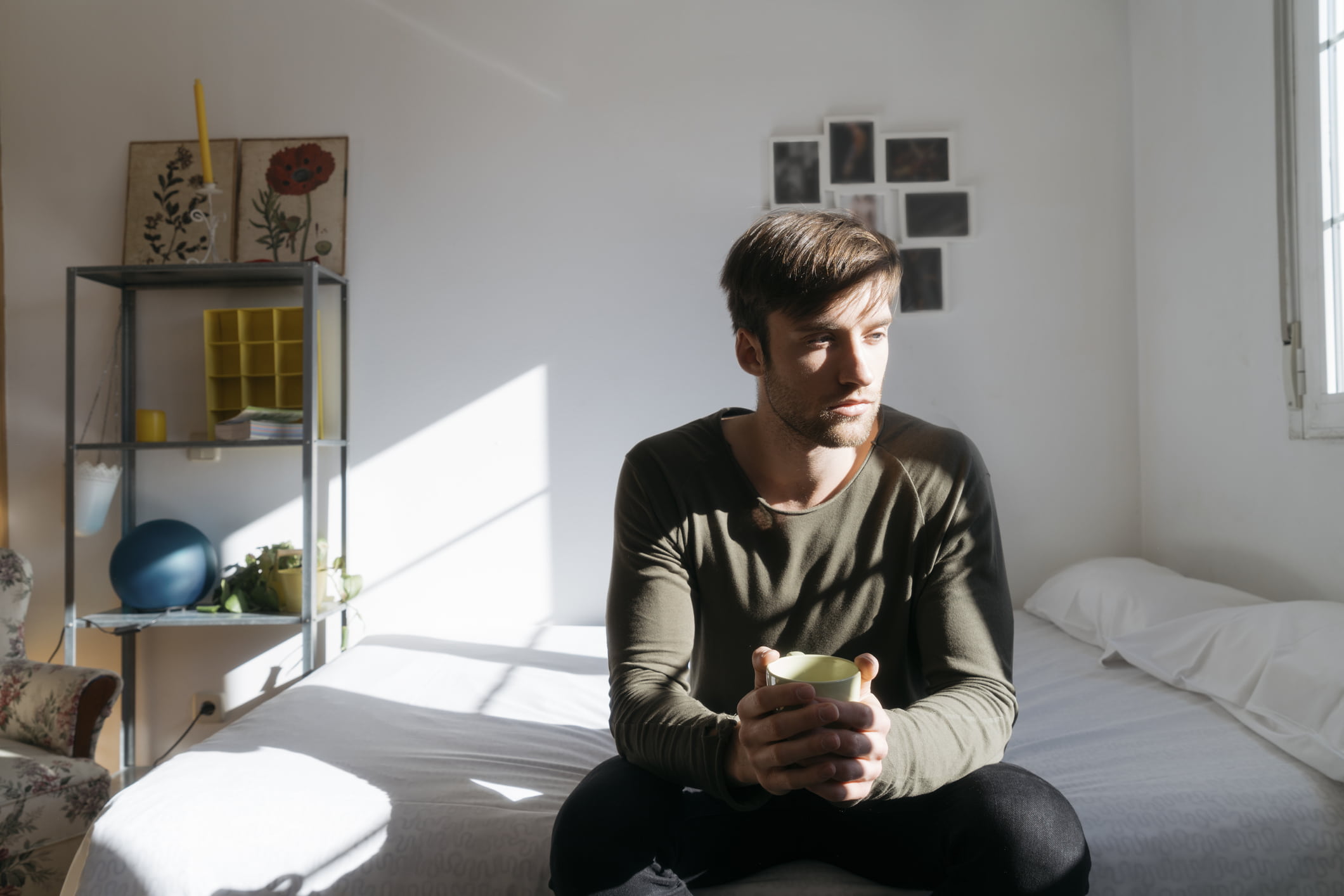 man-sitting-on-bed-with-coffee-stress-vs-anxiety