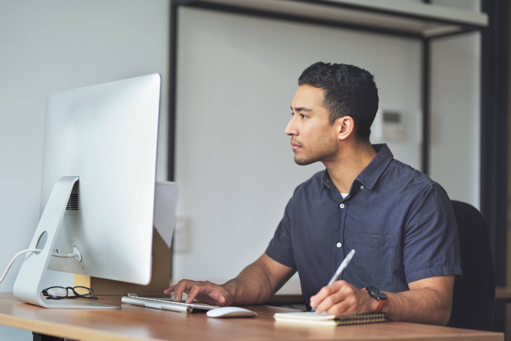 man-taking-notes-while-writing-a-mail-email-etiquette