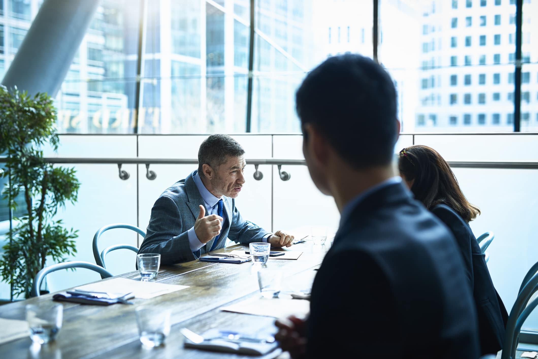 mature-man-talking-to-colleagues-in-modern-office-negative-reinforcement