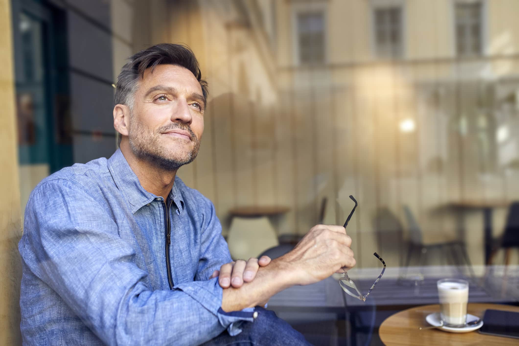 portrait-of-man-behind-windowpane-in-a-cafe-eustress-characteristics