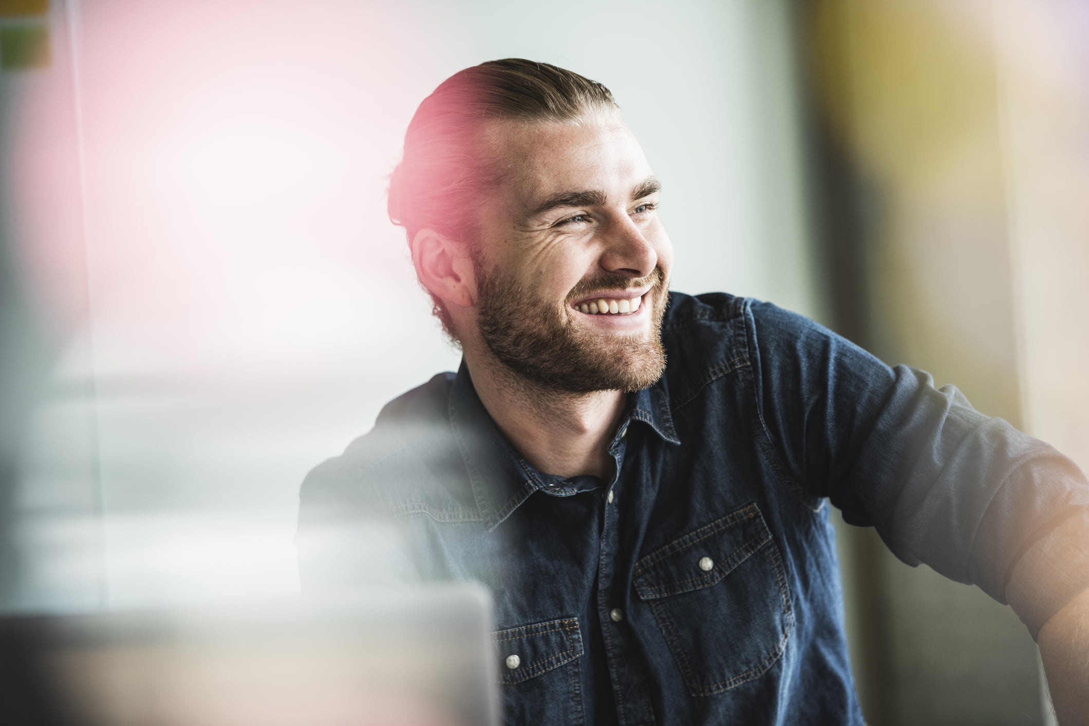 portrait-of-smiling-young-businessman-in-office-manifestation-journal-examples