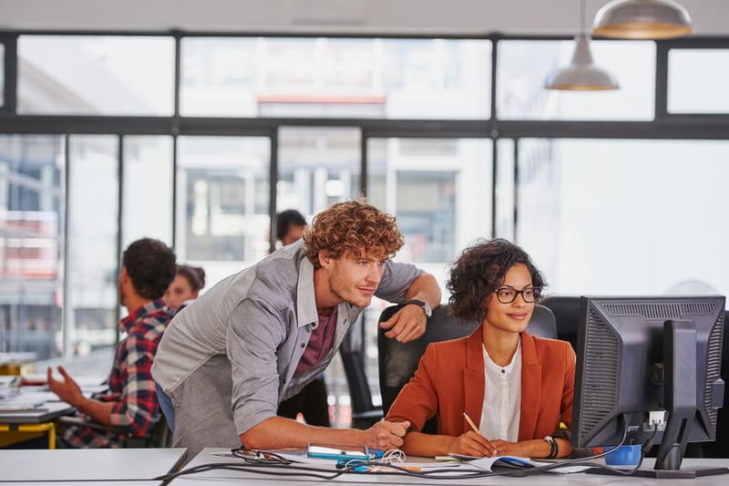 man-and-woman-working-together-in-an-office-reskilling