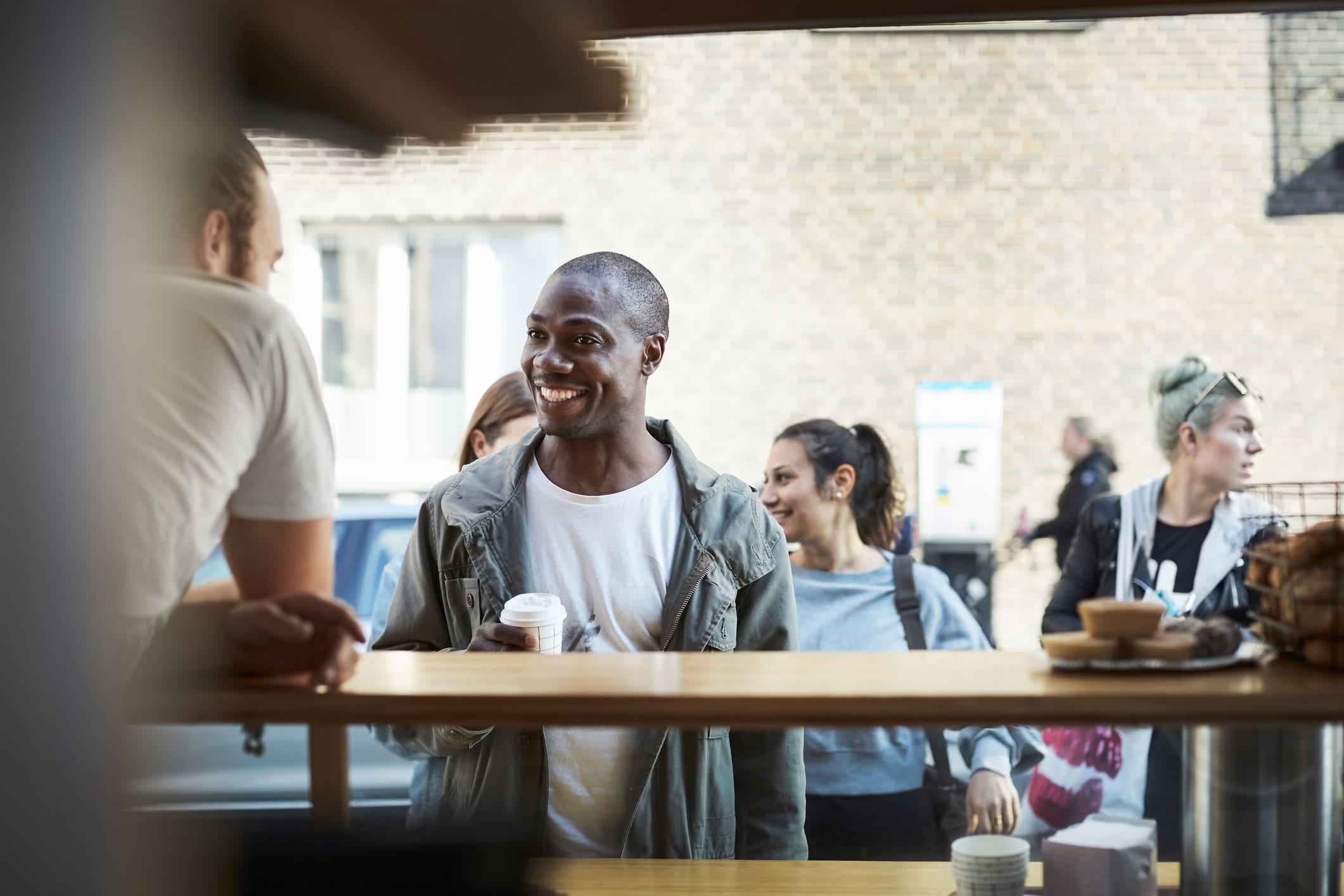 smiling-man-buying-coffee-getting-out-of-your-comfort-zone