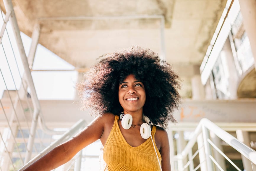 smiling-woman-earphones-be-a-better-ally