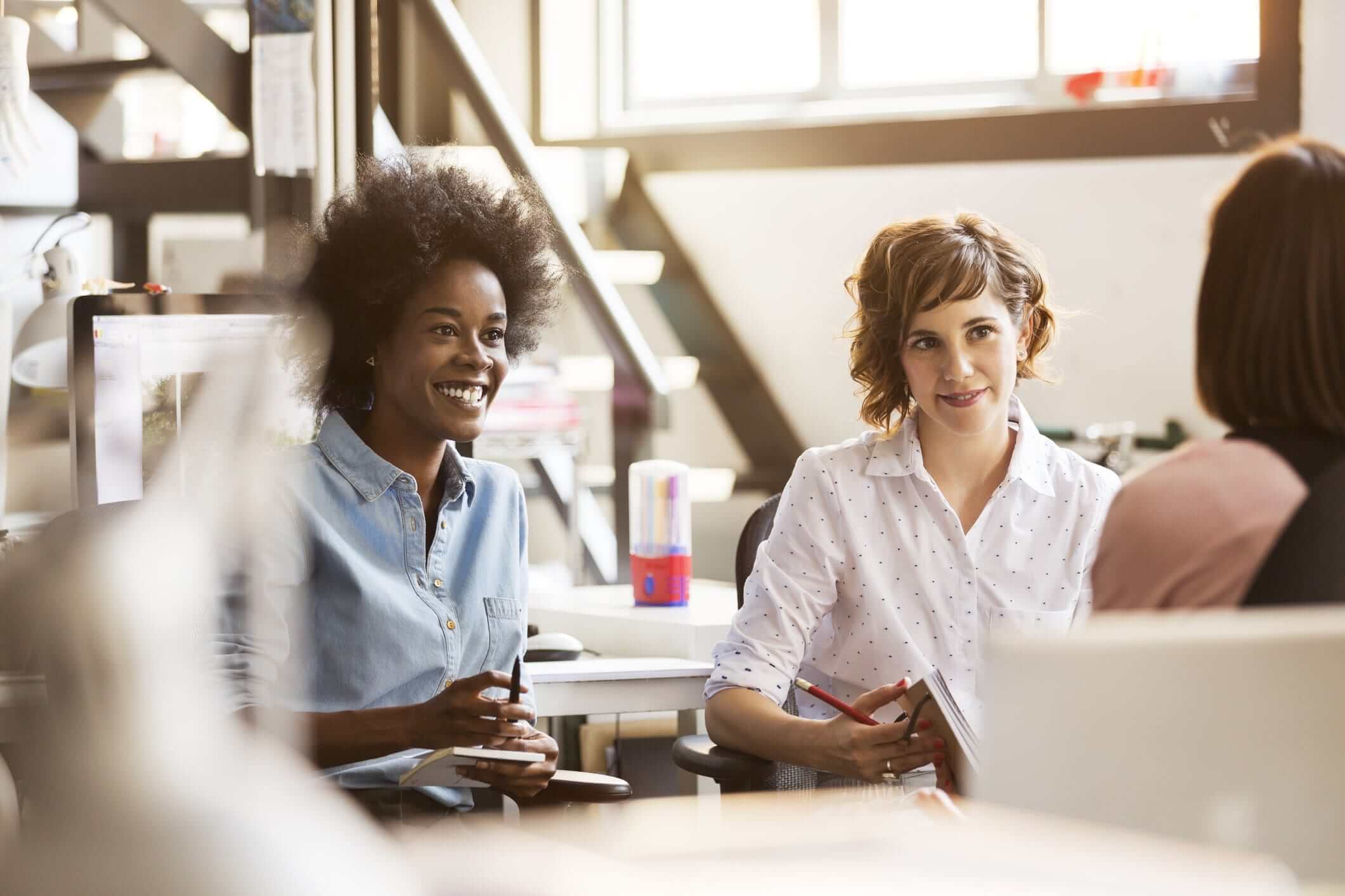 smiling-women-having-office-meeting