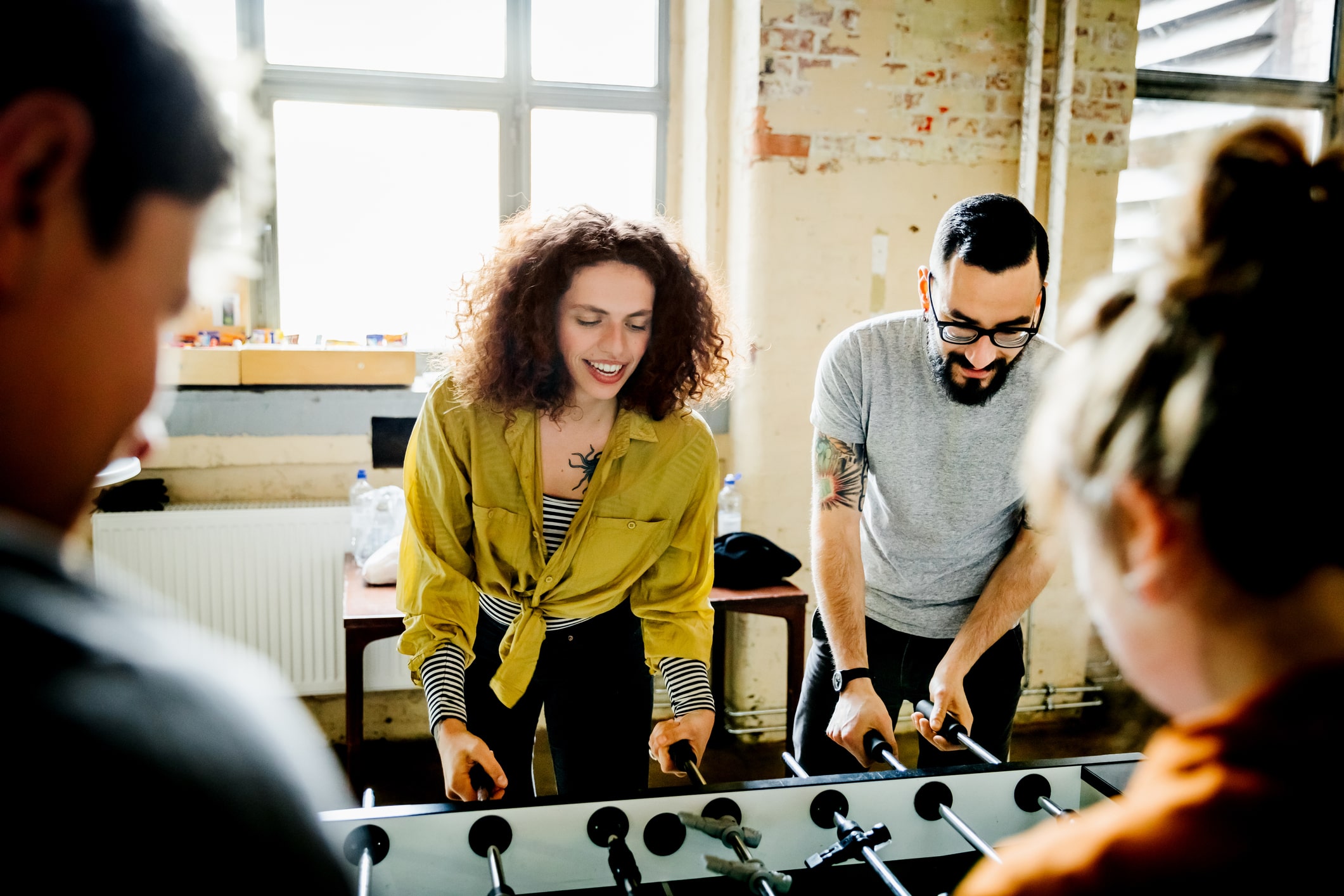 start-up-business-colleagues-playing-tableworkaholics-vs-working-long-hours