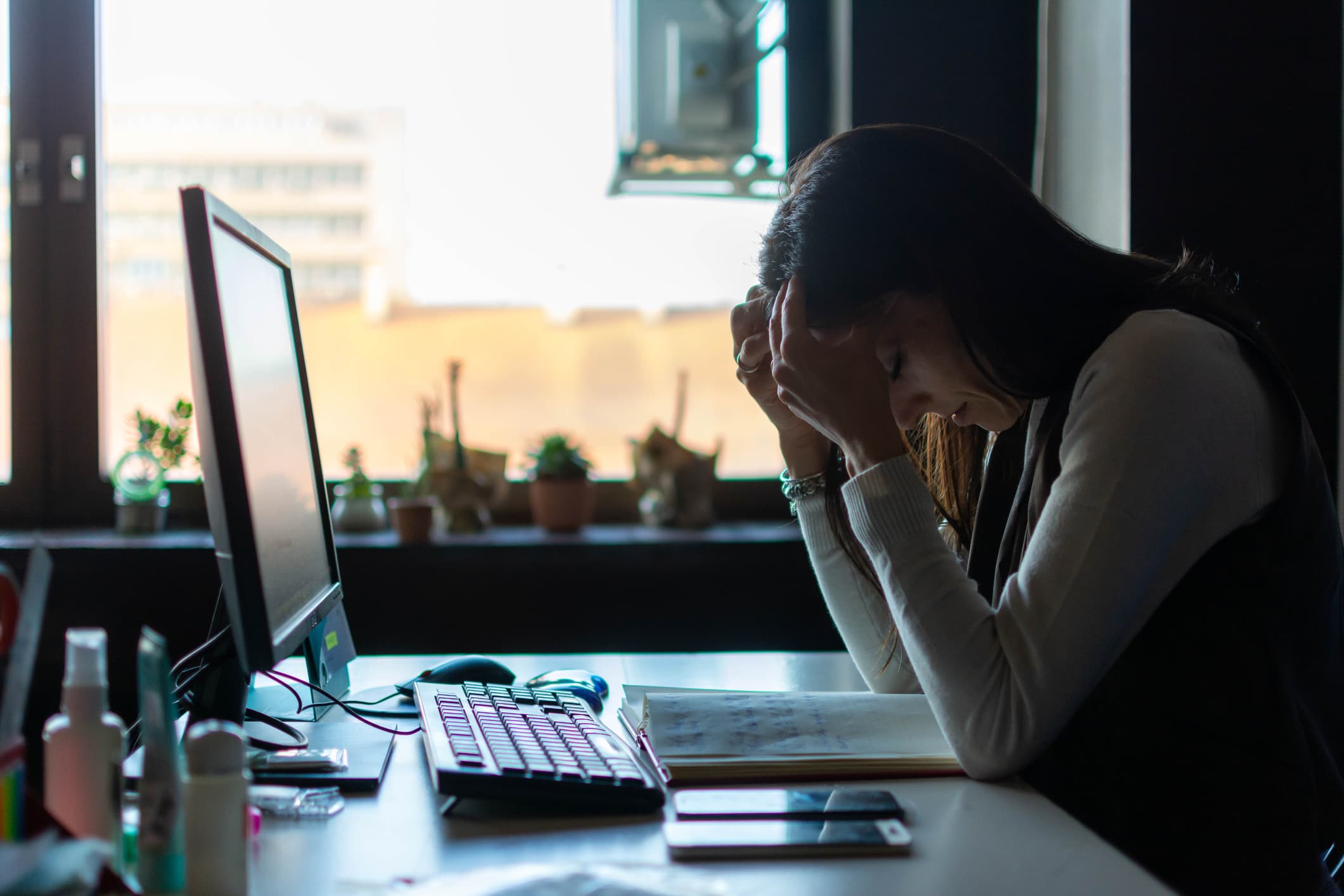 stressed-business-woman-on-desk-is-it-better-to-stay-at-one-company-or-move-around