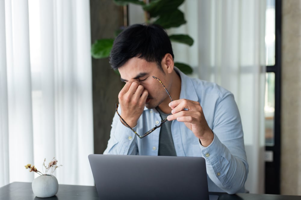 tired-man-using-his-laptop-self-care-and-work-life-balance