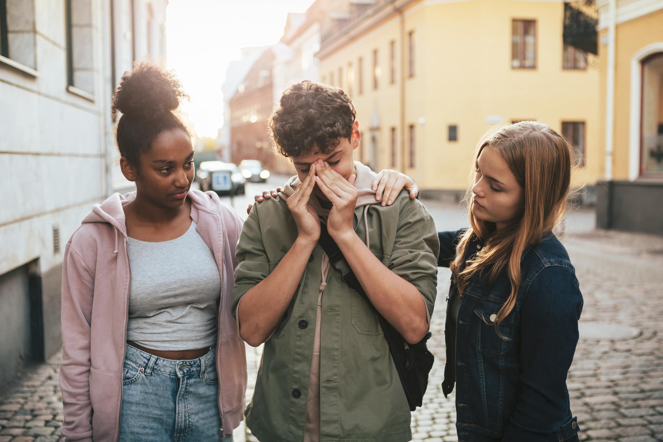 two-teenage-girls-comfort-their-friend-negative-reinforcement