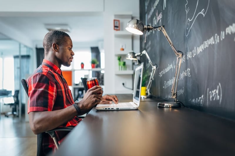 man-looking-at-his-laptop-upskilling