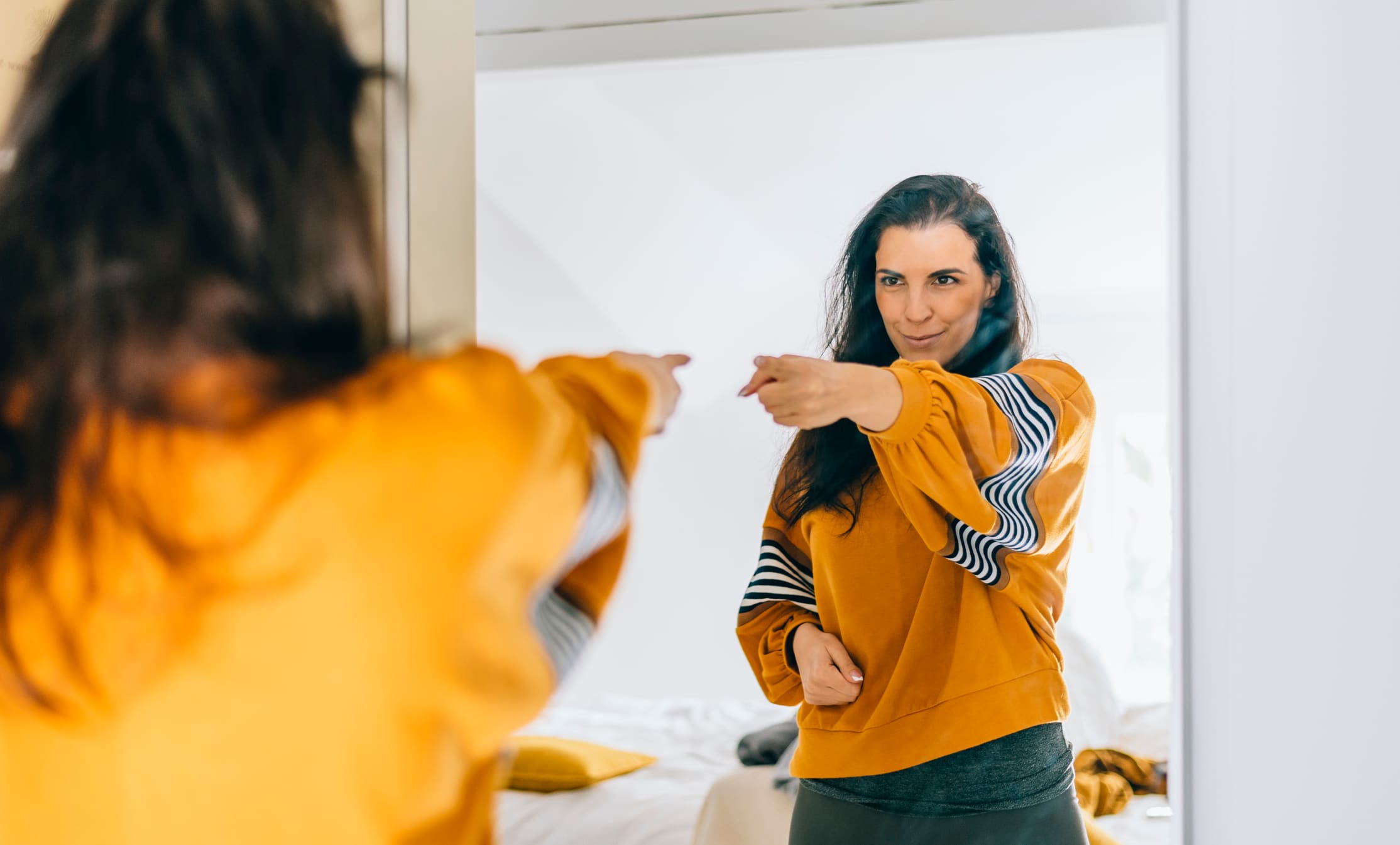 woman-pointing-at-herself-on-the-mirror-self-determination-theory