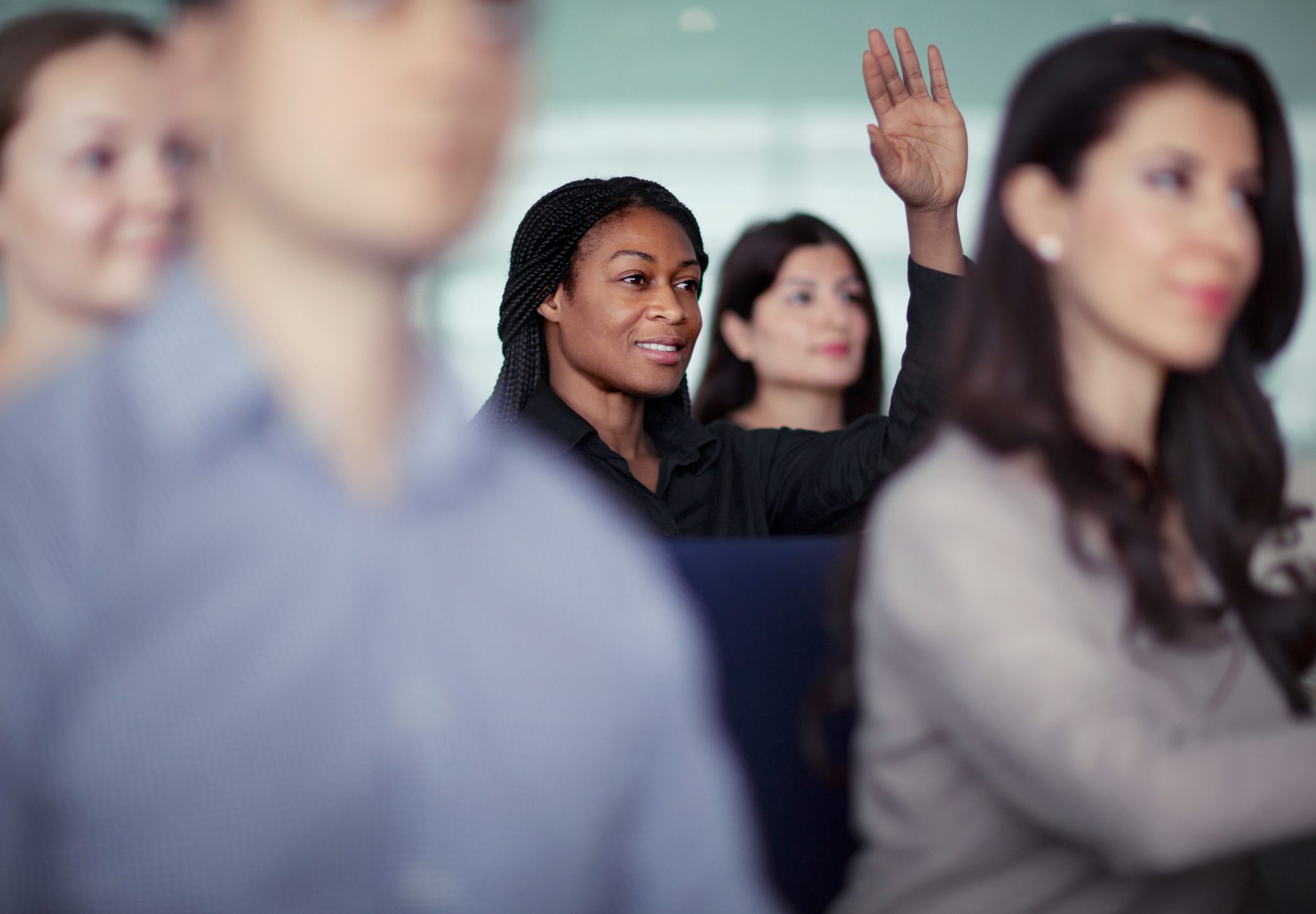 woman-raising-hand-in-group-seminar-workshop-short-term-professional-goals