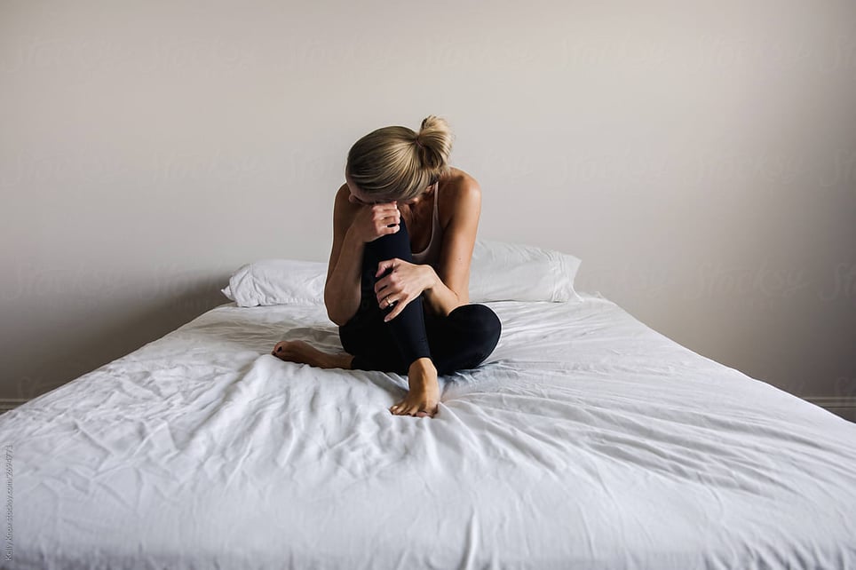 woman-sitting-on-bed-types-of-grief