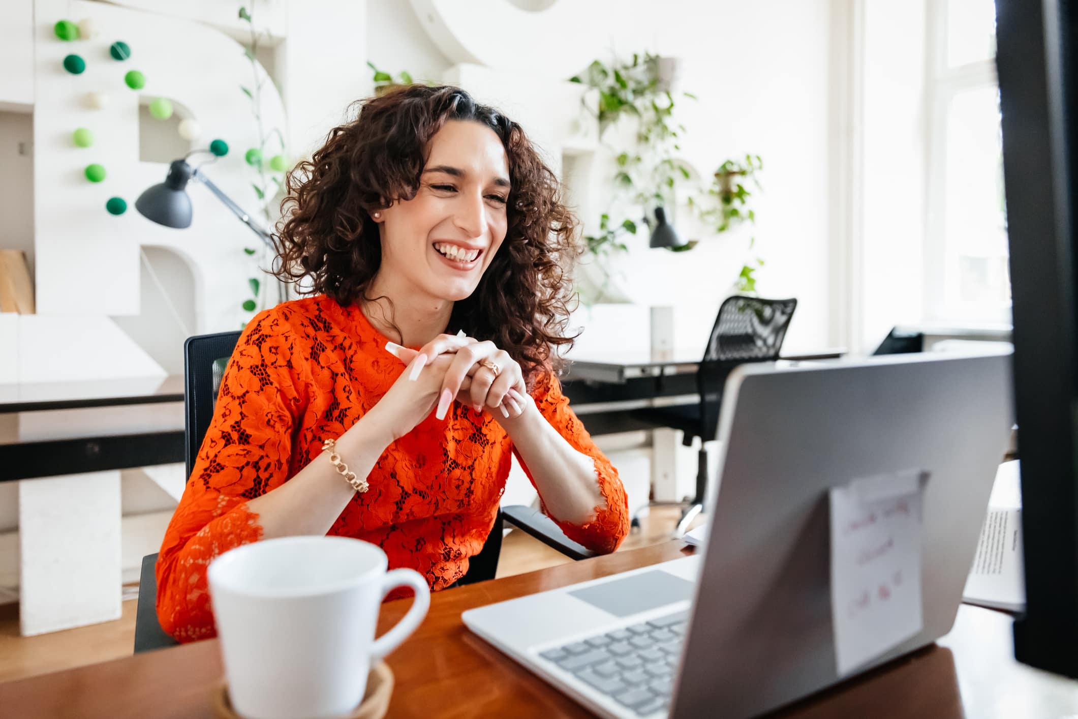 woman-smiling-while-working-what-is-a-manifestation-journal