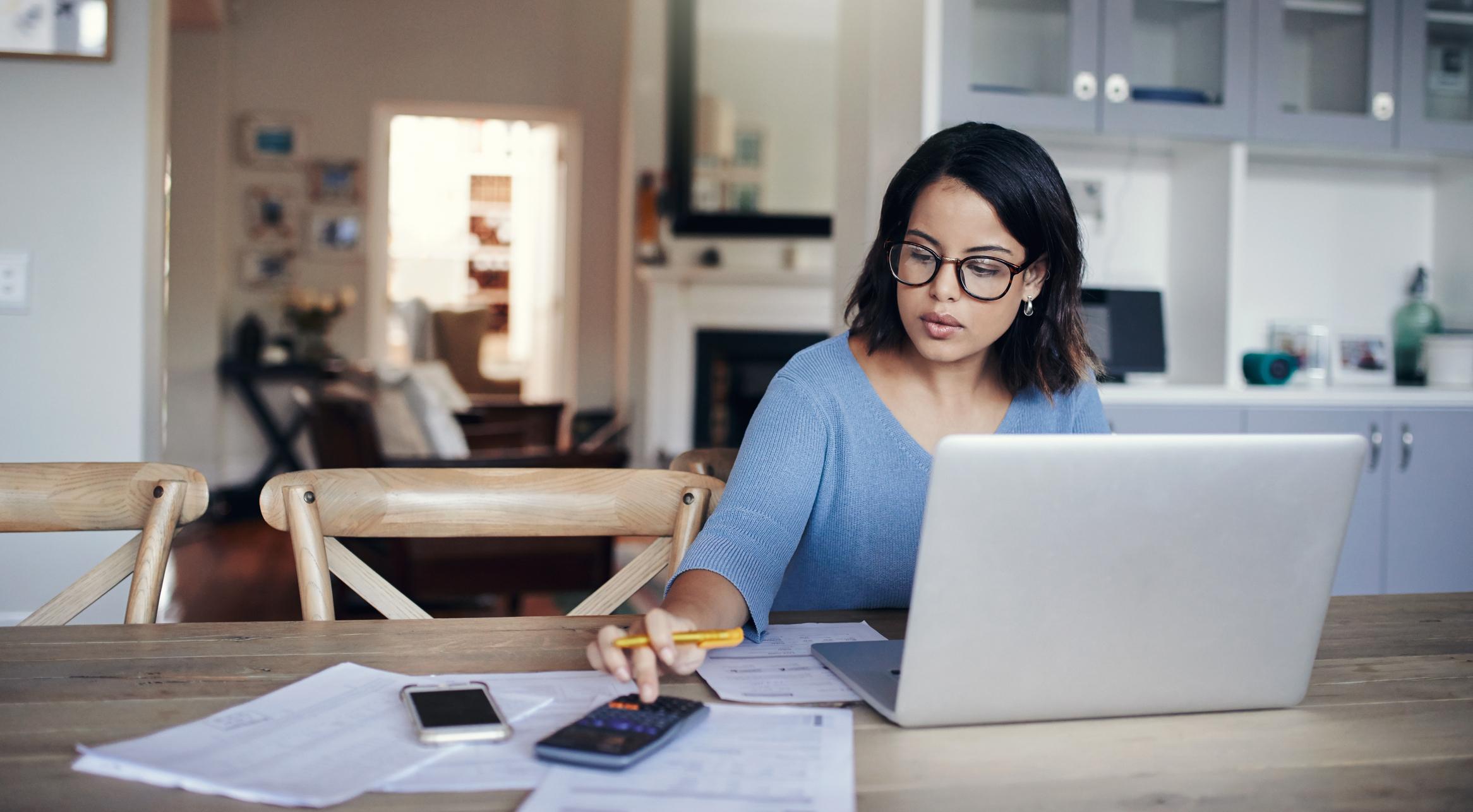 young-woman-using-a-laptop-and-calculator-what-is-my-earning-potential