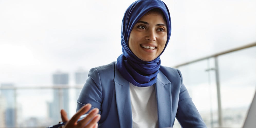 confident-woman-in-blue-headscarf-gestures-with-hand-what-is-a-leader