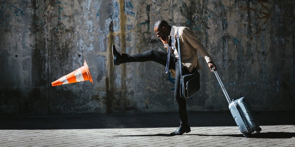 Man kicks a traffic cone in frustration -emotional-regulation-skills