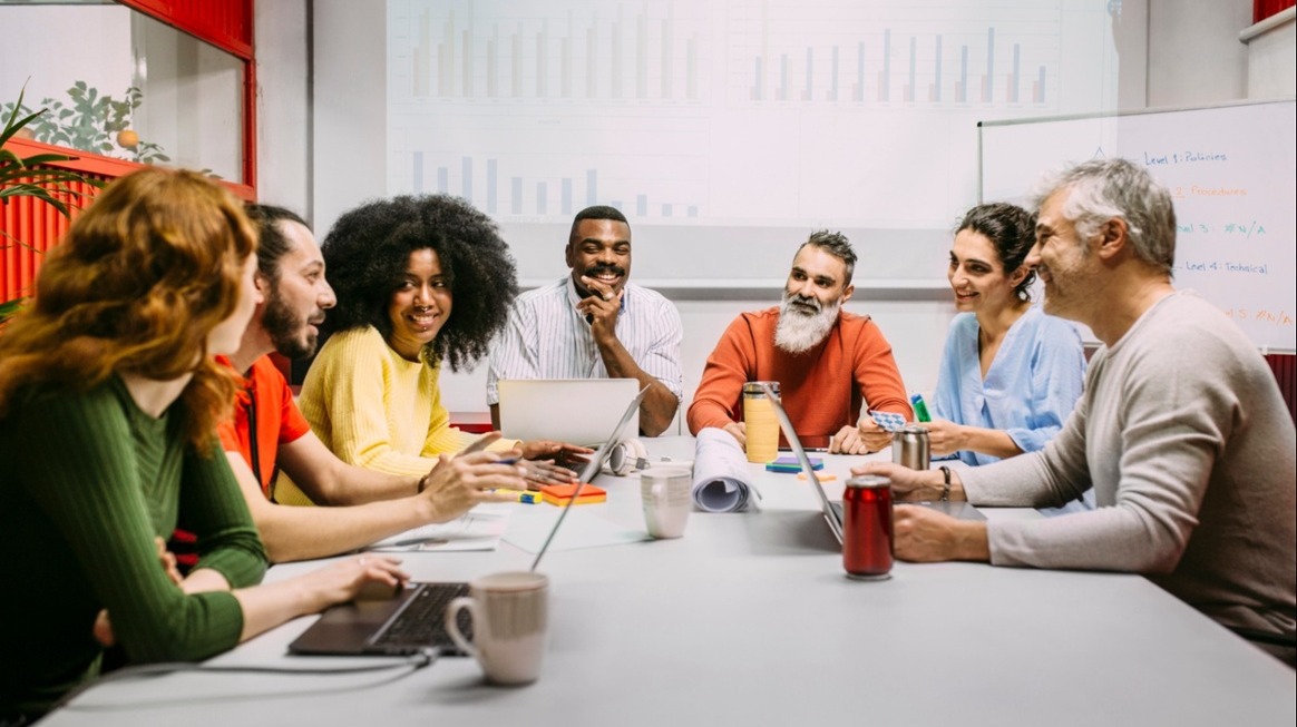 large-team-around-a-conference-table-corporate-coaching