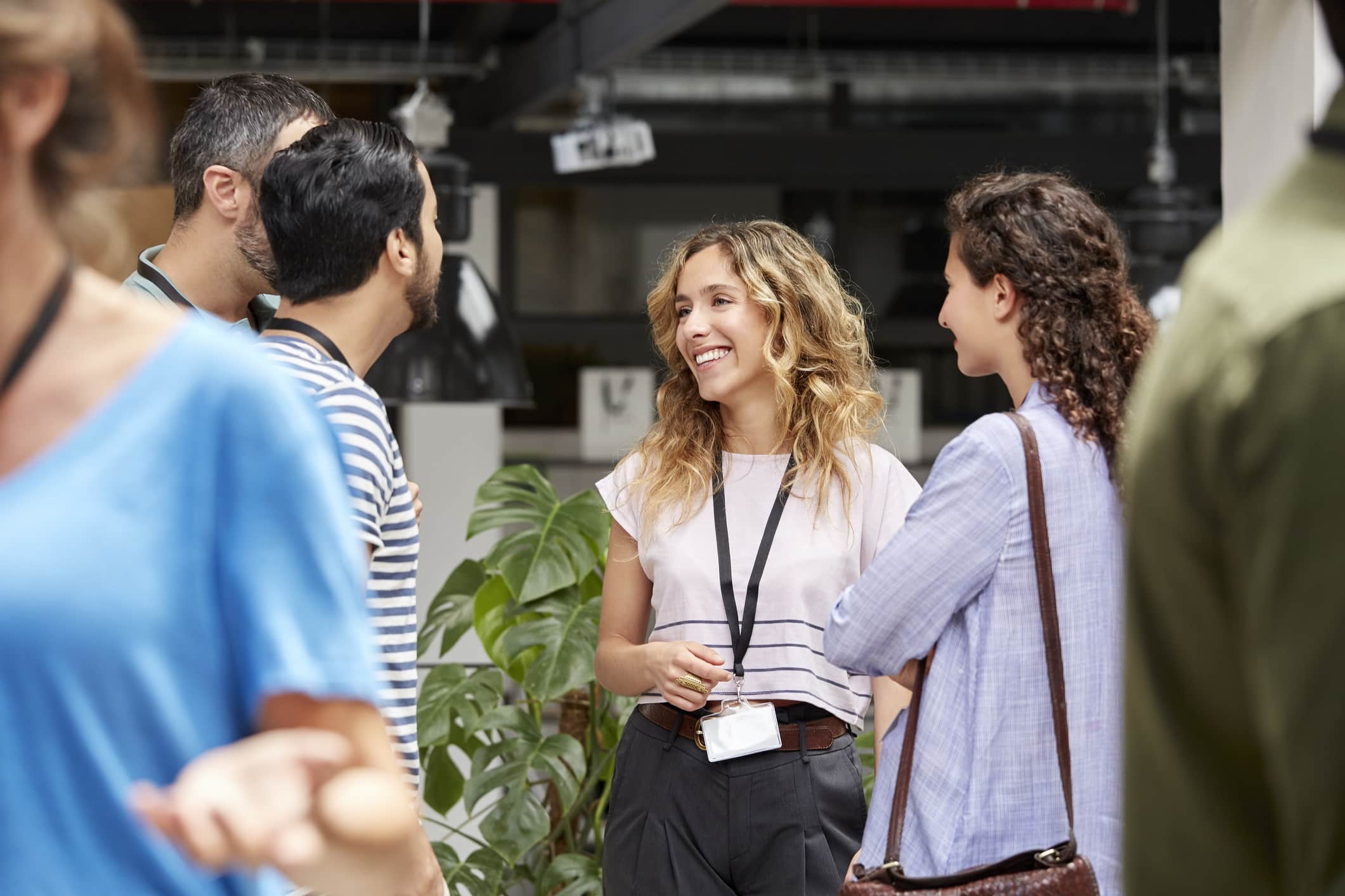 smiling-business-team-standing-during-meeting-negative-reinforcement