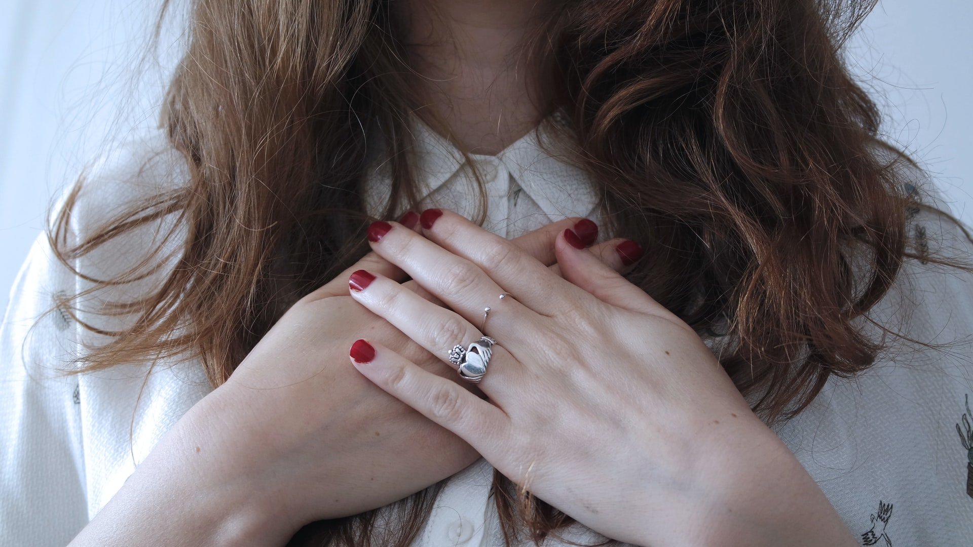 woman-holding-hands-over-her-heart-self-acceptance